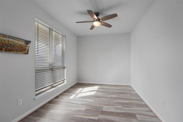 16816 Caperi Dr, Pflugerville, TX 78660 - spare room with a ceiling fan, wood finished floors, and baseboards