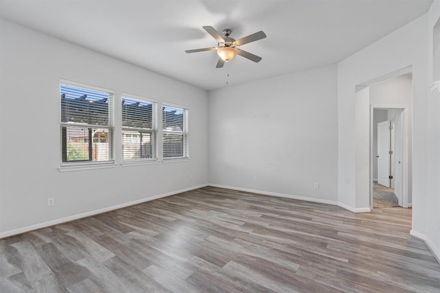 16816 Caperi Dr, Pflugerville, TX 78660 - spare room with a ceiling fan, wood finished floors, and baseboards