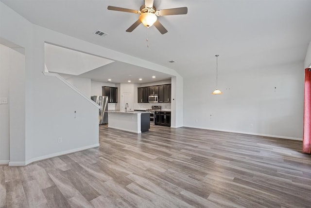 16816 Caperi Dr, Pflugerville, TX 78660 - unfurnished living room featuring a sink, ceiling fan, light wood finished floors, recessed lighting, and baseboards