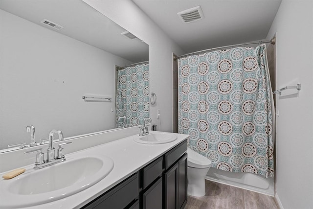 16816 Caperi Dr, Pflugerville, TX 78660 - full bathroom featuring wood finished floors, toilet, and double vanity