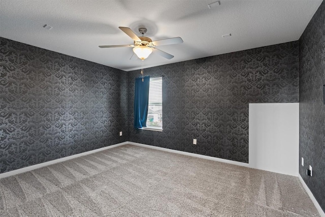 16816 Caperi Dr, Pflugerville, TX 78660 - carpeted empty room featuring a ceiling fan, wallpapered walls, and a textured ceiling