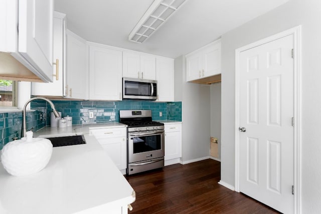 9325 Linkmeadow Dr, Austin, TX 78748 - kitchen featuring appliances with stainless steel finishes, a sink, dark wood finished floors, decorative backsplash, and light countertops
