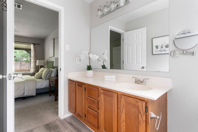 9325 Linkmeadow Dr, Austin, TX 78748 - ensuite bathroom featuring wood finished floors and vanity