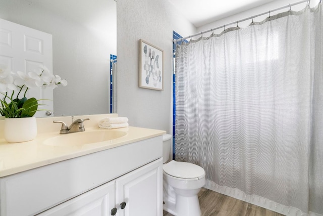 9325 Linkmeadow Dr, Austin, TX 78748 - bathroom with vanity, wood finished floors, toilet, and curtained shower