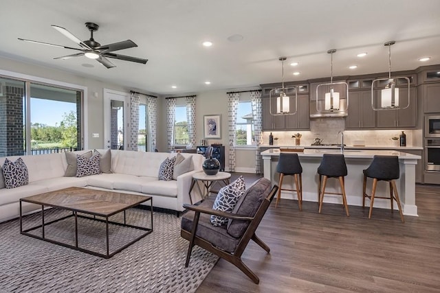 9512 Hamadryas Dr, Austin, TX 78744 - living area with dark wood-type flooring, recessed lighting, ceiling fan, and baseboards