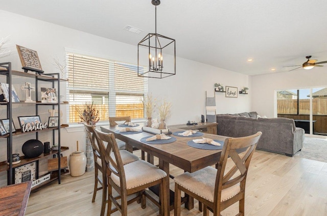 119 Nandina Path, Bastrop, TX 78602 - dining space with light wood finished floors, a chandelier, ceiling fan, and recessed lighting
