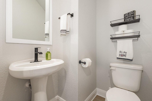 119 Nandina Path, Bastrop, TX 78602 - bathroom with toilet, a sink, and baseboards