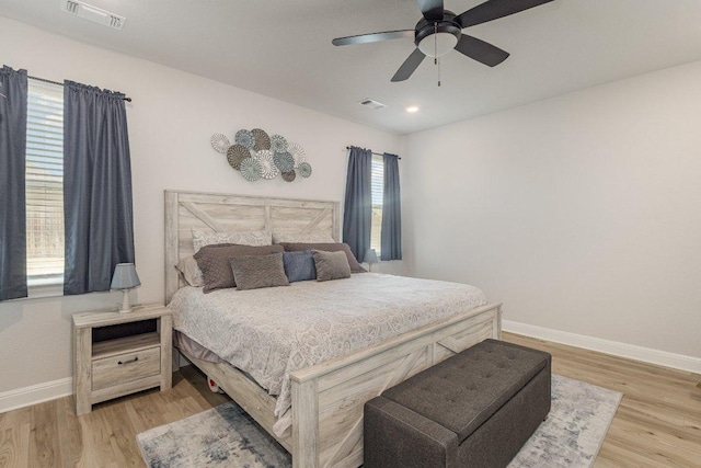 119 Nandina Path, Bastrop, TX 78602 - bedroom with baseboards, light wood-style floors, and a ceiling fan