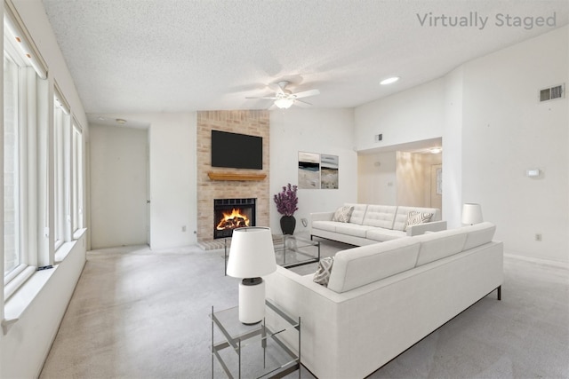 13204 Tamayo Dr, Austin, TX 78729 - living area featuring a ceiling fan, a brick fireplace, a textured ceiling, light carpet, and lofted ceiling