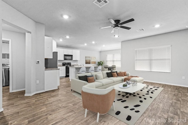 6000 Shanjia Dr, Austin, TX 78724 - living room with ceiling fan, light wood-type flooring, baseboards, and recessed lighting