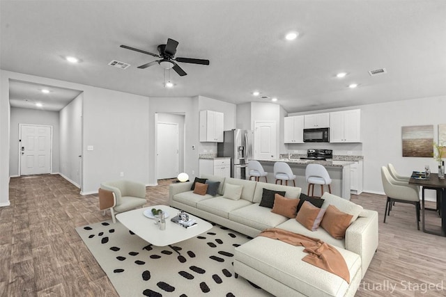 6000 Shanjia Dr, Austin, TX 78724 - living room featuring recessed lighting, baseboards, light wood finished floors, and ceiling fan