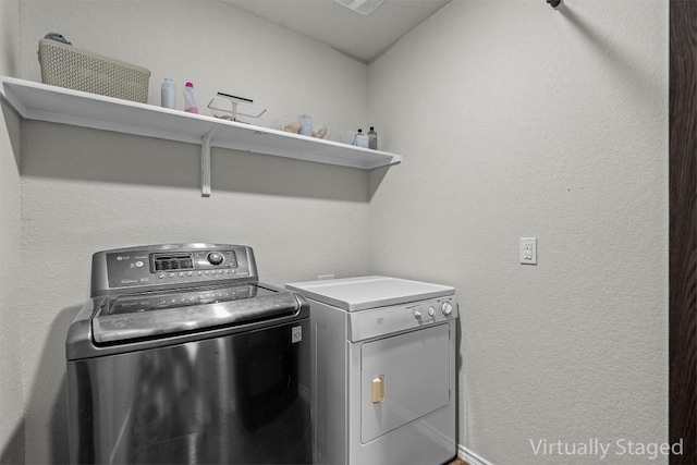 6000 Shanjia Dr, Austin, TX 78724 - laundry area featuring washing machine and clothes dryer and a textured wall