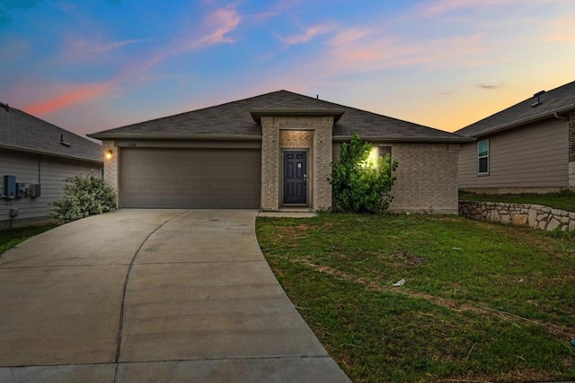 6000 Shanjia Dr, Austin, TX 78724 - view of front of home featuring an attached garage, concrete driveway, a front yard, and brick siding