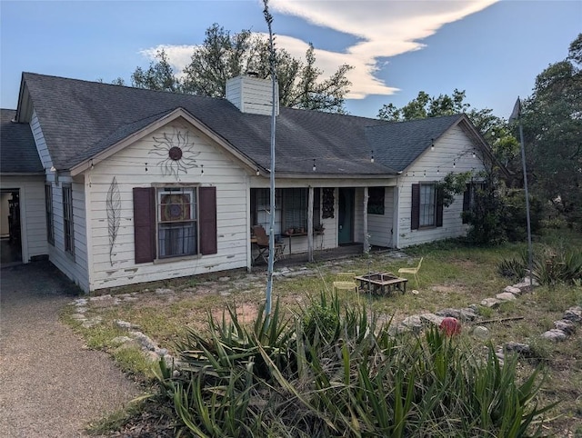13603 Overland Pass, Bee Cave, TX 78738 - view of front facade with a fire pit, a chimney, and a shingled roof
