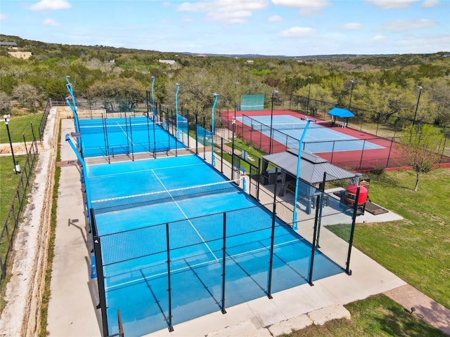 4908 Canyon Ranch Trl, Spicewood, TX 78669 - view of tennis court with a forest view