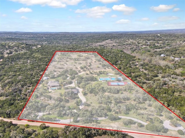 4908 Canyon Ranch Trl, Spicewood, TX 78669 - aerial view of property and surrounding area with property boundaries highlighted and a heavily wooded area