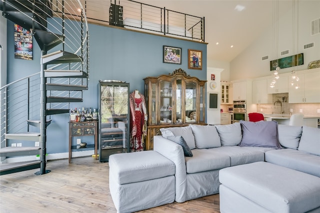 4908 Canyon Ranch Trl, Spicewood, TX 78669 - living room with high vaulted ceiling, stairs, and wood finished floors