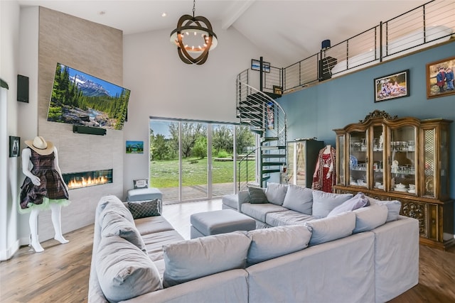 4908 Canyon Ranch Trl, Spicewood, TX 78669 - living area featuring high vaulted ceiling, beam ceiling, a chandelier, wood finished floors, and a tile fireplace