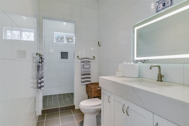 4908 Canyon Ranch Trl, Spicewood, TX 78669 - bathroom featuring tile patterned floors, vanity, a walk in shower, toilet, and tile walls