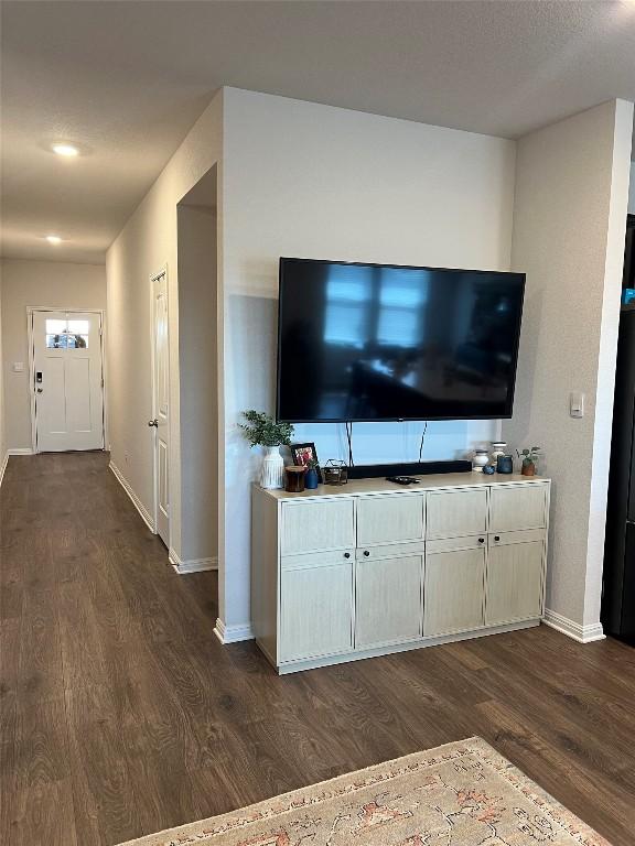 248 Lone Cedar Rd, Marble Falls, TX 78654 - unfurnished living room featuring dark wood finished floors and baseboards