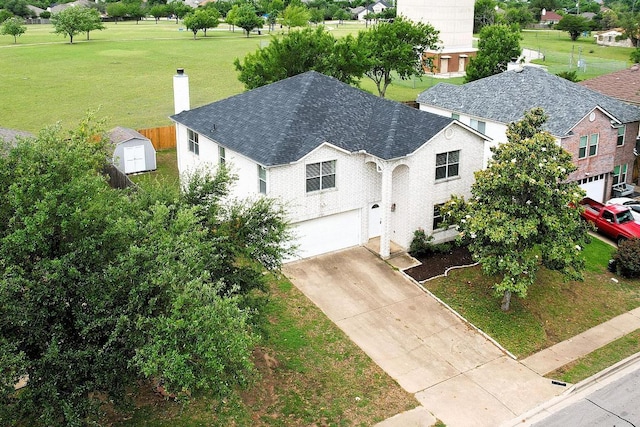 2727 High Point Dr, Round Rock, TX 78664 - view of front facade featuring a chimney, a garage, driveway, and a front yard