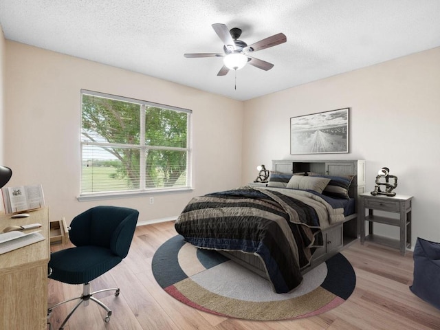 2727 High Point Dr, Round Rock, TX 78664 - bedroom with wood finished floors, ceiling fan, a textured ceiling, and baseboards