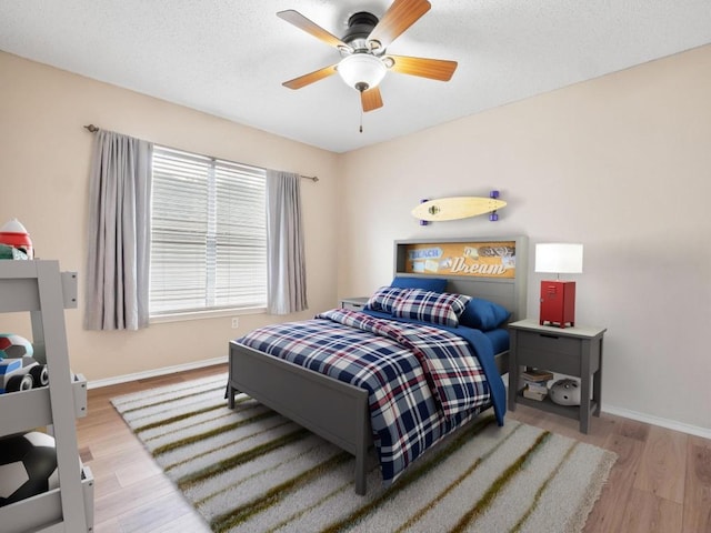 2727 High Point Dr, Round Rock, TX 78664 - bedroom with wood finished floors, baseboards, and a ceiling fan