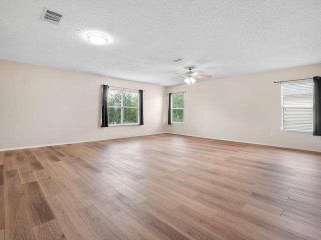 2727 High Point Dr, Round Rock, TX 78664 - spare room featuring a ceiling fan, light wood-style flooring, a textured ceiling, and baseboards