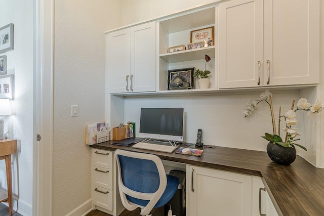 305 Dashing Sycamore St, San Marcos, TX 78666 - office area with built in desk, a textured wall, and baseboards