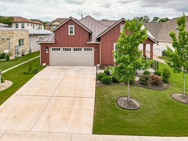 305 Dashing Sycamore St, San Marcos, TX 78666 - view of front of home with board and batten siding, driveway, and a front lawn