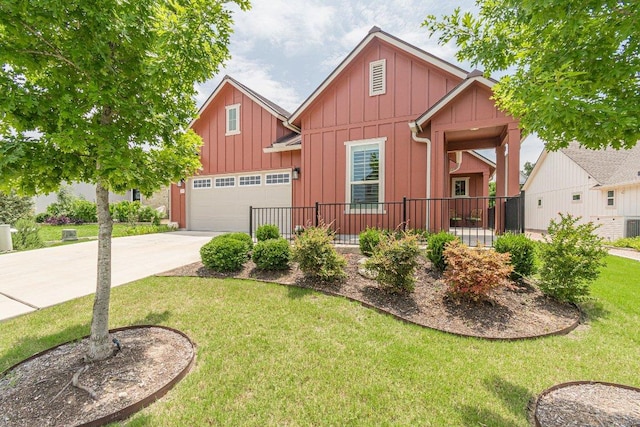 305 Dashing Sycamore St, San Marcos, TX 78666 - view of front of home with board and batten siding, concrete driveway, a front yard, and an attached garage
