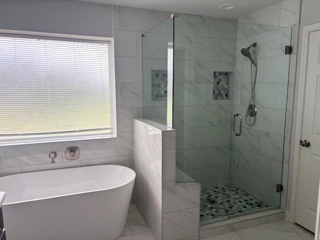 15114 Wells Port Dr, Austin, TX 78728 - bathroom featuring a soaking tub, a shower stall, and marble finish floors