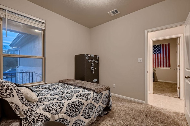233 Mcfarland St, Georgetown, TX 78628 - bedroom with carpet flooring, baseboards, and tile patterned floors