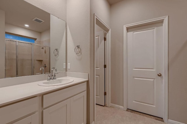 233 Mcfarland St, Georgetown, TX 78628 - bathroom featuring vanity, a tile shower, and tile patterned floors