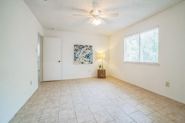 409 Mountain Laurel Dr, Cedar Park, TX 78613 - unfurnished room with a textured ceiling, a ceiling fan, light tile patterned flooring, and baseboards