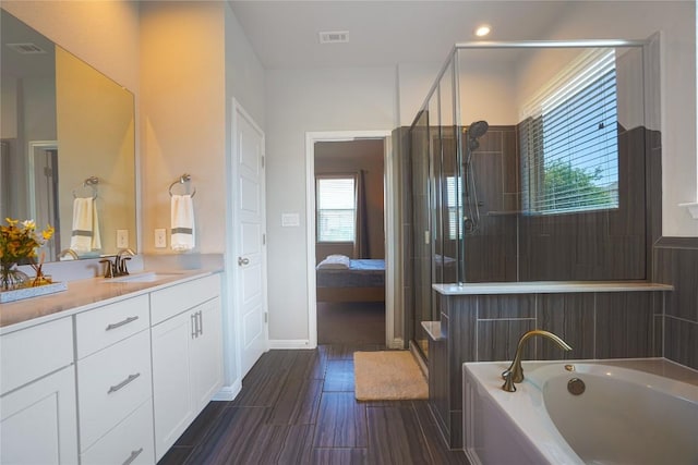 2207 Land Grant Way, Round Rock, TX 78664 - bathroom with vanity, a garden tub, a shower stall, ensuite bath, and recessed lighting