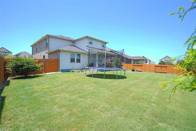2207 Land Grant Way, Round Rock, TX 78664 - back of house with a trampoline and a fenced backyard