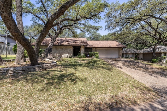 8400 Shenandoah Dr, Austin, TX 78753 - mid-century inspired home featuring an attached garage, brick siding, and driveway