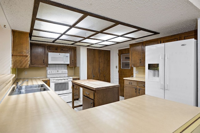 8400 Shenandoah Dr, Austin, TX 78753 - kitchen featuring white appliances, a sink, a kitchen island, and wooden counters