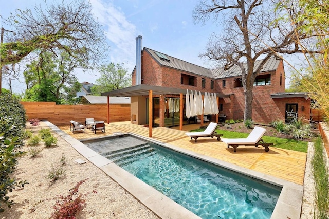1601 Woodlawn Blvd, Austin, TX 78703 - back of property featuring a wooden deck, a metal roof, a standing seam roof, brick siding, and a patio