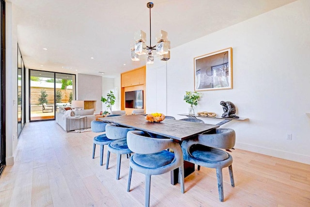 1601 Woodlawn Blvd, Austin, TX 78703 - dining space with light wood-style flooring, a chandelier, recessed lighting, baseboards, and a wall of windows