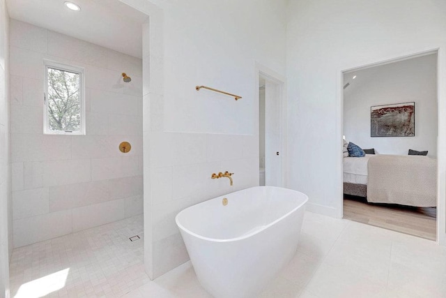 1601 Woodlawn Blvd, Austin, TX 78703 - ensuite bathroom featuring a freestanding bath, a walk in shower, tile patterned flooring, recessed lighting, and tile walls
