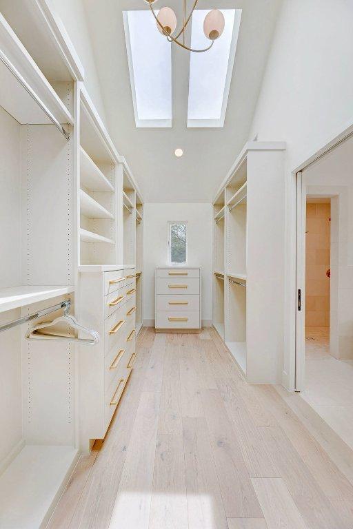 1601 Woodlawn Blvd, Austin, TX 78703 - walk in closet featuring light wood-style flooring and a skylight