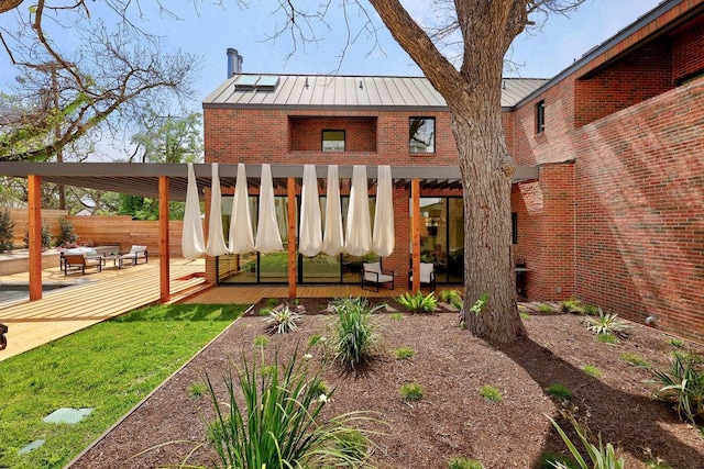 1601 Woodlawn Blvd, Austin, TX 78703 - view of front of home featuring a standing seam roof, a deck, brick siding, and metal roof