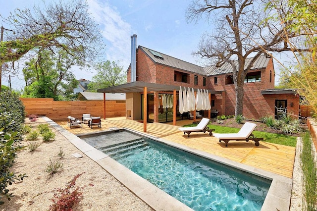 1601 Woodlawn Blvd, Austin, TX 78703 - back of property featuring a deck, metal roof, a standing seam roof, brick siding, and a patio area