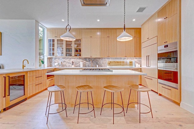 1601 Woodlawn Blvd, Austin, TX 78703 - kitchen featuring light brown cabinets, decorative backsplash, a sink, a kitchen island, and light countertops