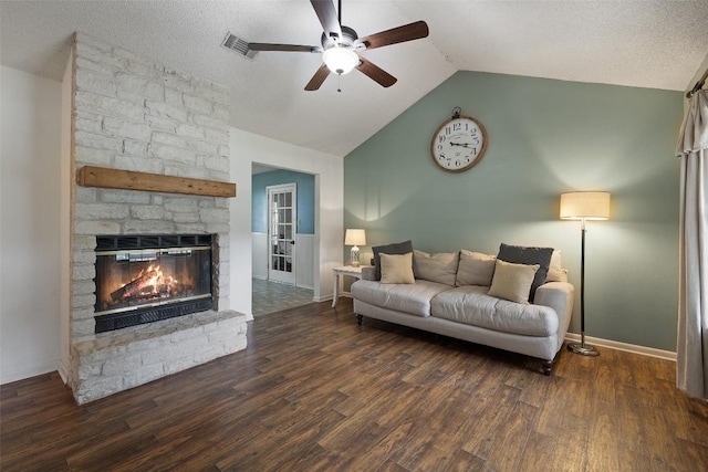 506 S Main St, Thrall, TX 76578 - living room with a ceiling fan, vaulted ceiling, a stone fireplace, wood finished floors, and a textured ceiling