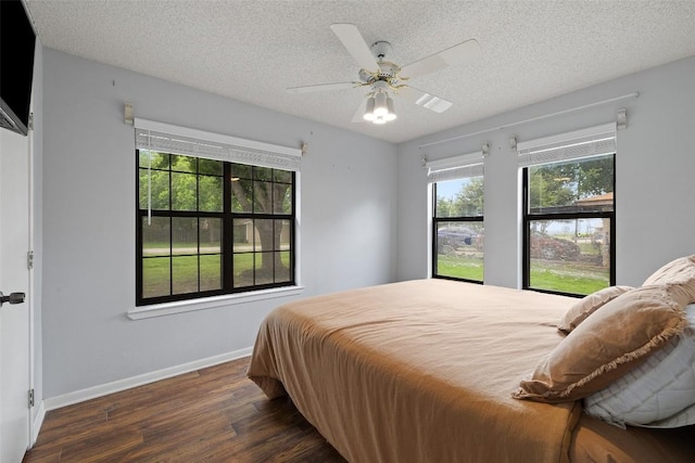 506 S Main St, Thrall, TX 76578 - bedroom featuring wood finished floors, a textured ceiling, baseboards, and a ceiling fan
