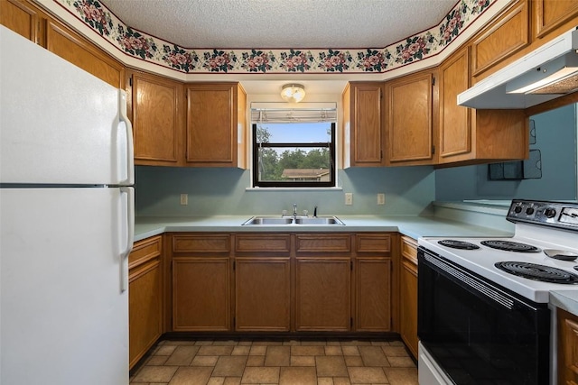 506 S Main St, Thrall, TX 76578 - kitchen featuring freestanding refrigerator, range with electric stovetop, a sink, under cabinet range hood, and light countertops