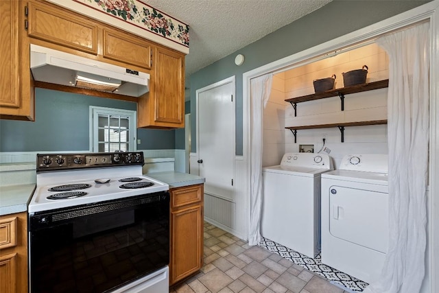 506 S Main St, Thrall, TX 76578 - kitchen with electric stove, under cabinet range hood, open shelves, washing machine and dryer, and light countertops